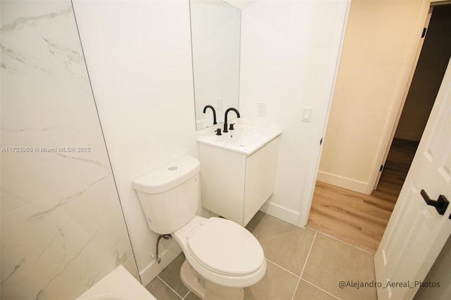 bathroom featuring toilet, vanity, and tile patterned flooring