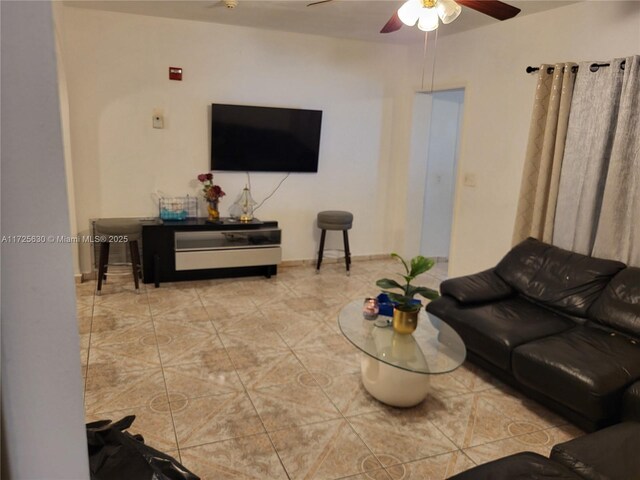 living room with a ceiling fan and tile patterned flooring