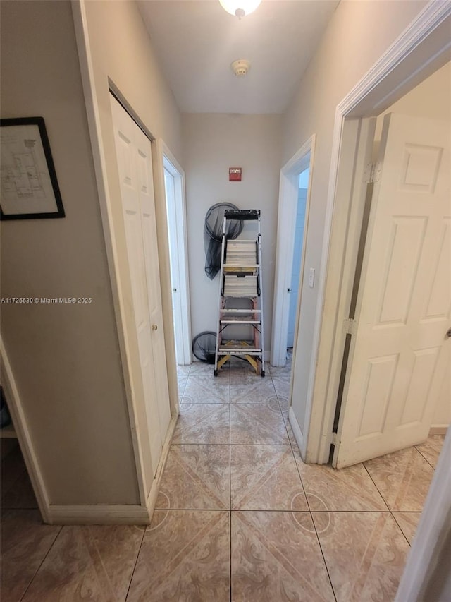 hallway with light tile patterned floors