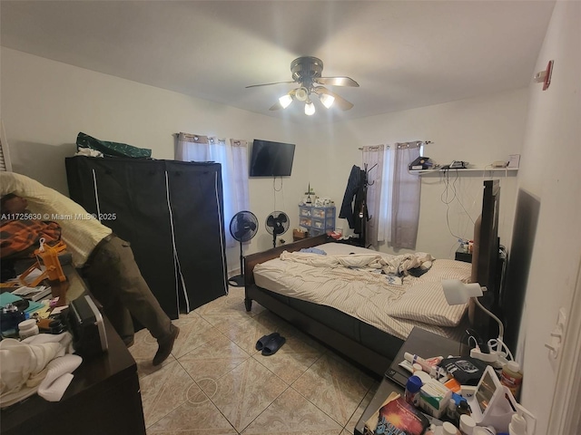 bedroom with light tile patterned floors and ceiling fan