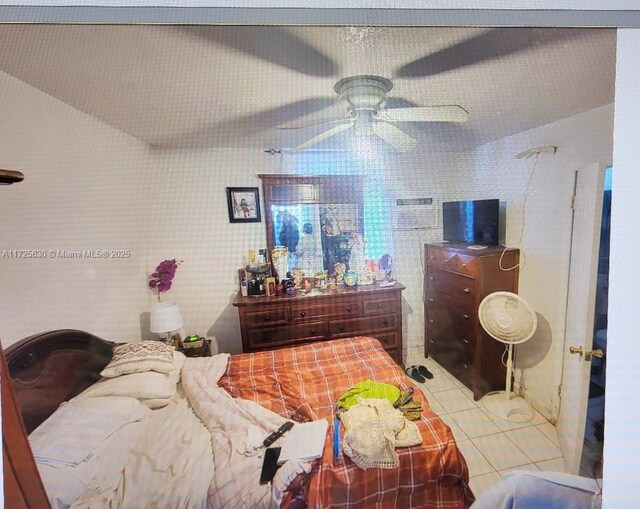 tiled bedroom with ceiling fan