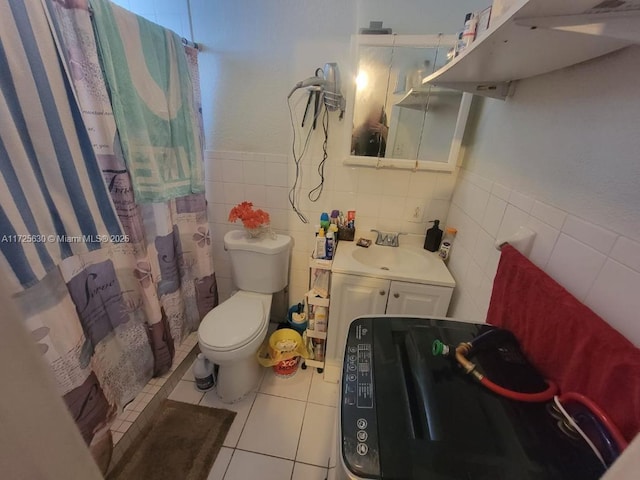 full bathroom featuring toilet, a shower with curtain, tile patterned flooring, and tile walls