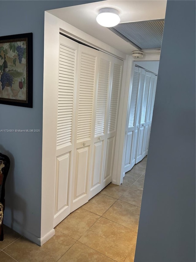 corridor with light tile patterned flooring