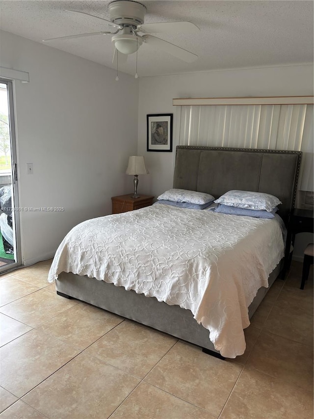 bedroom featuring ceiling fan, access to exterior, a textured ceiling, and light tile patterned floors