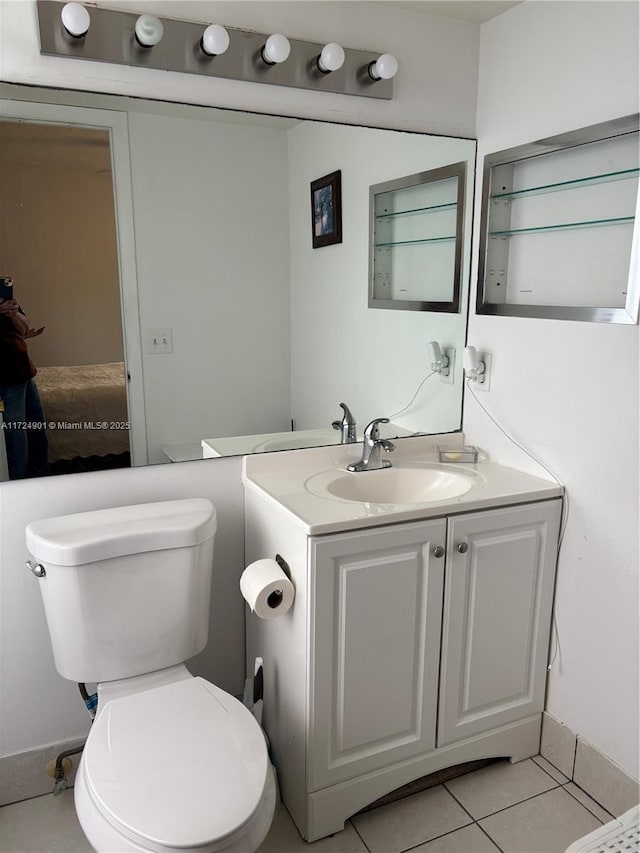 bathroom with vanity, tile patterned floors, and toilet