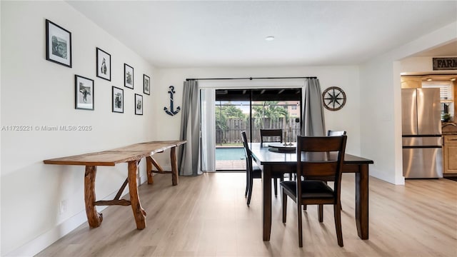 dining space with light hardwood / wood-style floors