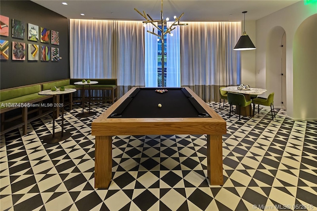 playroom with a notable chandelier and billiards