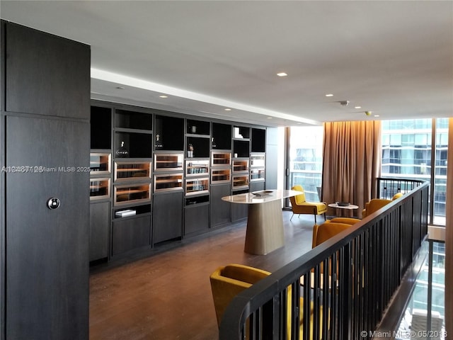 interior space with floor to ceiling windows and wood-type flooring