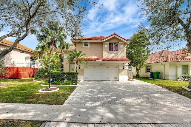 mediterranean / spanish-style house with a front yard and a garage