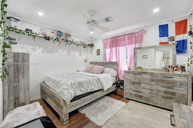 bedroom featuring ornamental molding, ceiling fan, and wood-type flooring