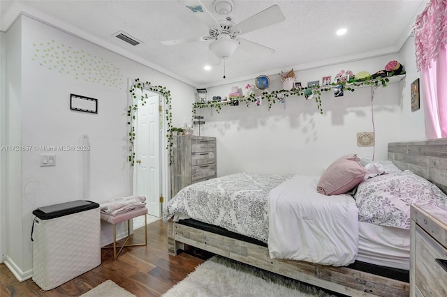 bedroom featuring ceiling fan, dark hardwood / wood-style flooring, and ornamental molding