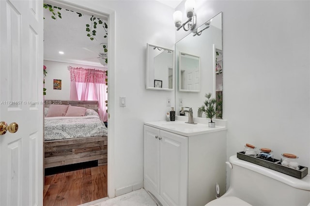 bathroom featuring an inviting chandelier, vanity, and toilet