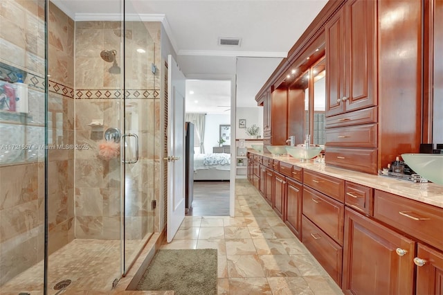 bathroom featuring ornamental molding, an enclosed shower, and vanity