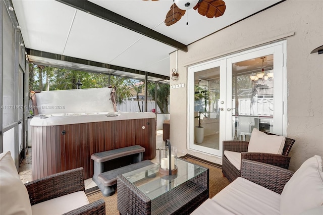 sunroom with ceiling fan, a jacuzzi, french doors, and beamed ceiling