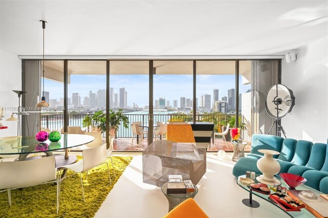 living room featuring floor to ceiling windows and concrete flooring