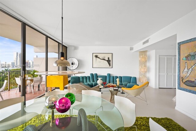 dining area featuring a wall of windows and plenty of natural light