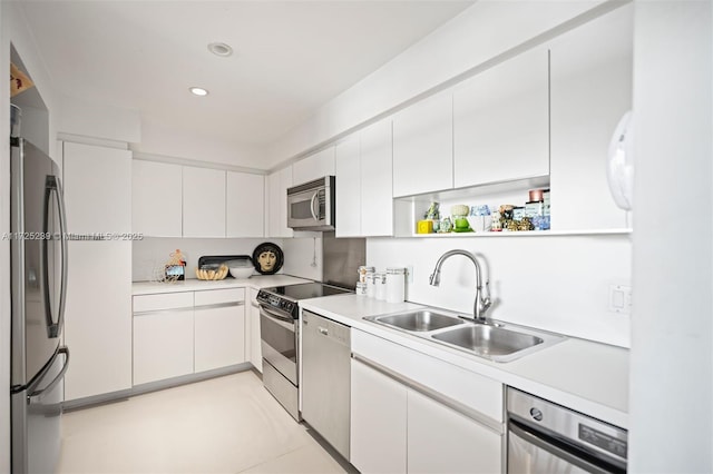 kitchen featuring white cabinetry, stainless steel appliances, and sink