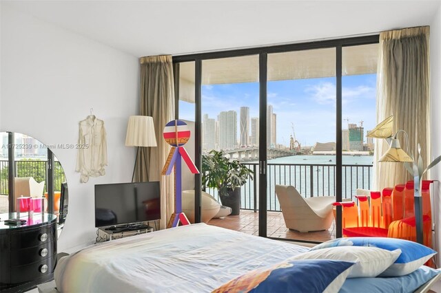 bedroom featuring floor to ceiling windows, access to outside, and multiple windows