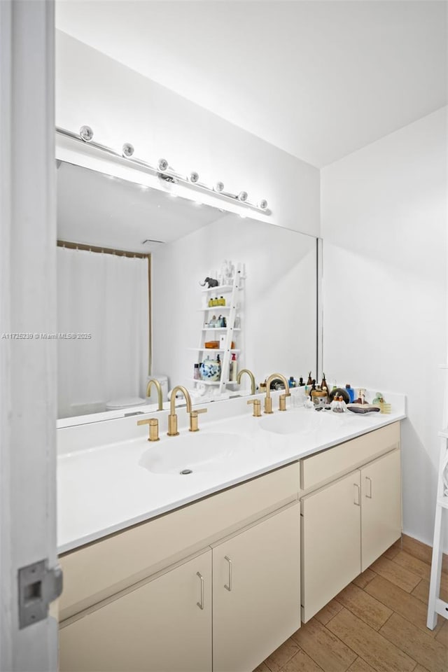 bathroom featuring hardwood / wood-style flooring and vanity