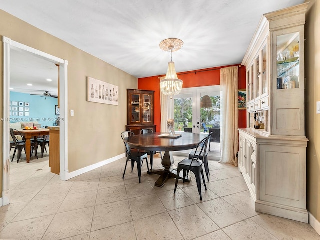 dining room with ceiling fan with notable chandelier and french doors