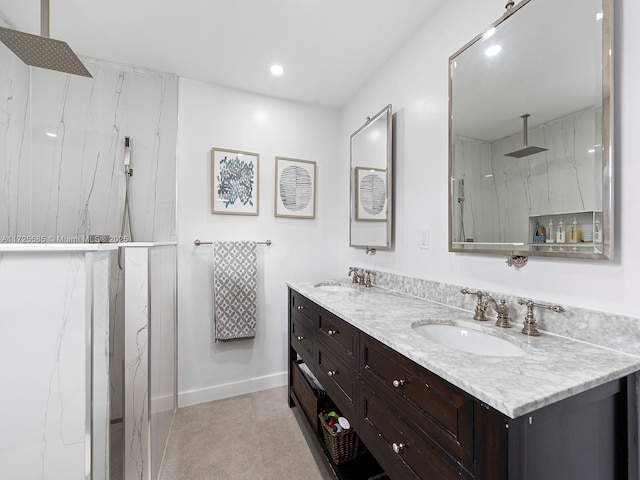 bathroom with a shower, vanity, and tile patterned floors