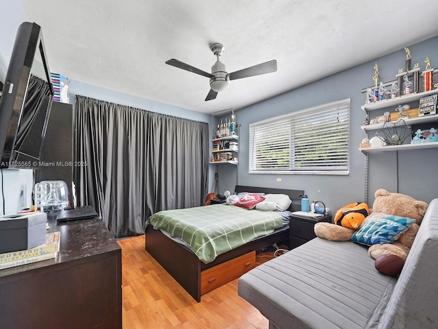 bedroom with ceiling fan and light hardwood / wood-style floors