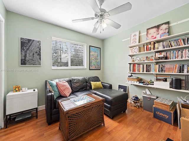 sitting room with ceiling fan and light hardwood / wood-style floors