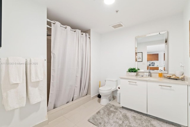 bathroom featuring toilet, vanity, tile patterned flooring, and a shower with curtain