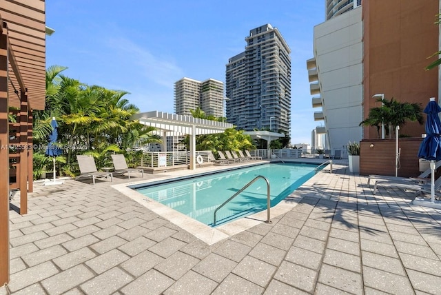 view of swimming pool with a pergola and a patio area