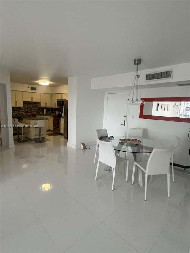 dining space featuring light tile patterned floors