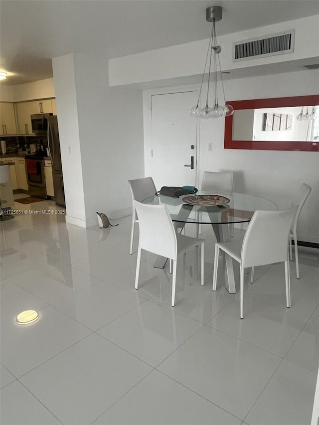 dining space featuring light tile patterned flooring