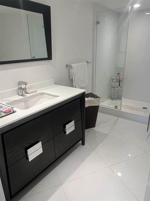 bathroom with a shower, tile patterned floors, and vanity