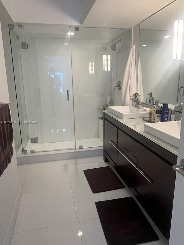 bathroom with vanity, an enclosed shower, and tile patterned flooring