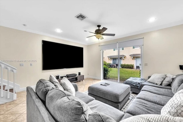 living room with ceiling fan, light tile patterned floors, and crown molding