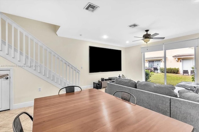 dining space with crown molding, ceiling fan, and light tile patterned floors