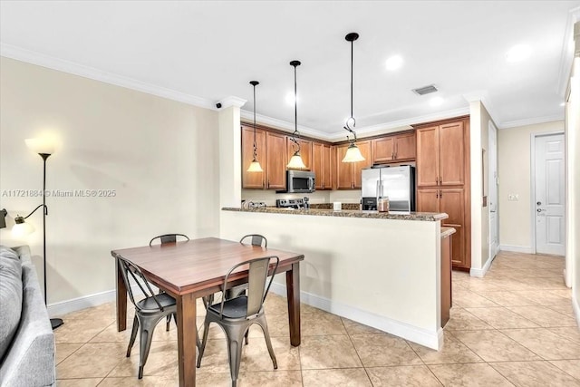 kitchen featuring stainless steel appliances, kitchen peninsula, ornamental molding, pendant lighting, and light tile patterned flooring