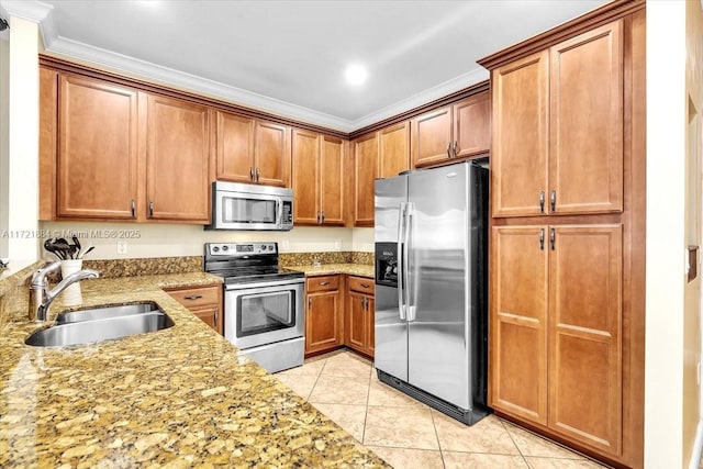 kitchen with appliances with stainless steel finishes, light stone countertops, light tile patterned floors, ornamental molding, and sink