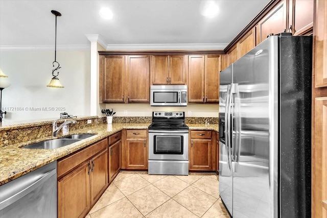 kitchen with stainless steel appliances, hanging light fixtures, light stone countertops, ornamental molding, and sink