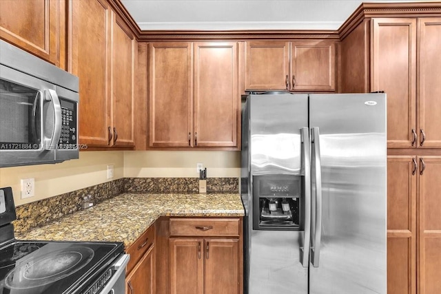 kitchen with appliances with stainless steel finishes and light stone counters