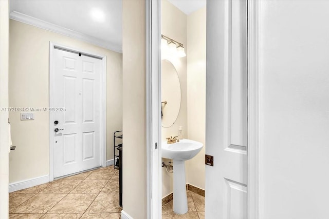 bathroom with ornamental molding, tile patterned flooring, and sink