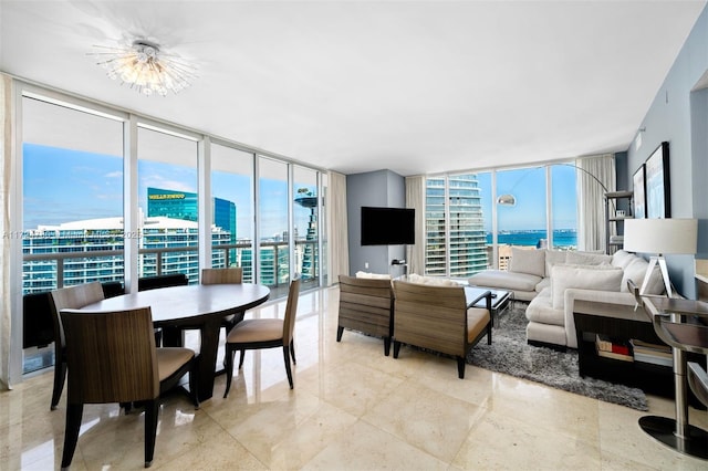 living room featuring a notable chandelier and expansive windows