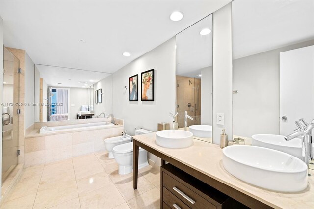 full bathroom with toilet, tile patterned floors, plus walk in shower, a bidet, and vanity