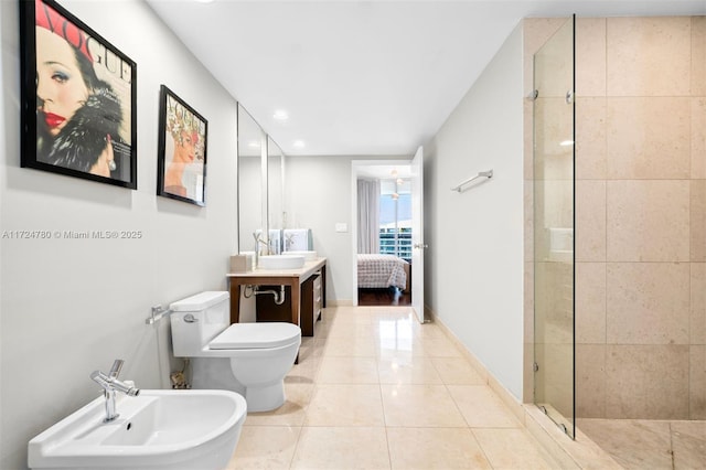 bathroom featuring toilet, an enclosed shower, a bidet, and vanity