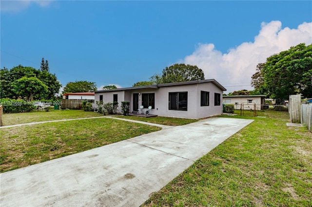 ranch-style home with a front lawn