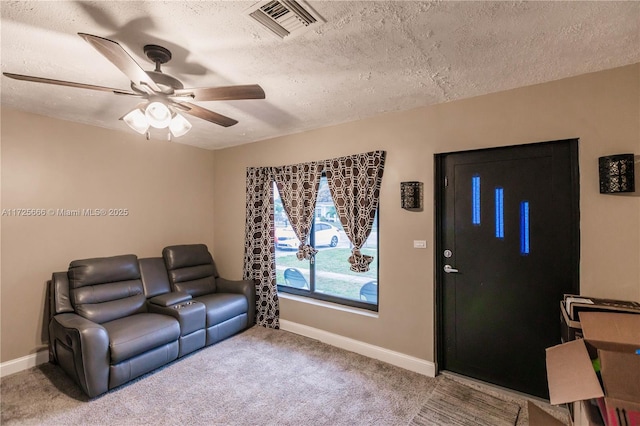 living room featuring a textured ceiling, ceiling fan, and carpet flooring