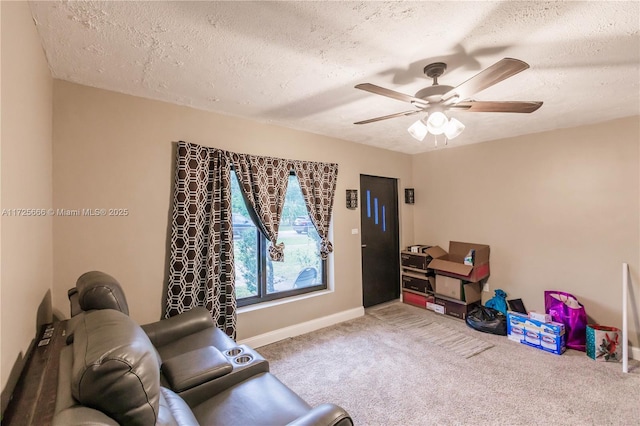 interior space featuring a textured ceiling, ceiling fan, and carpet floors