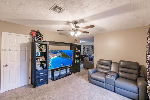 carpeted living room featuring a textured ceiling and ceiling fan