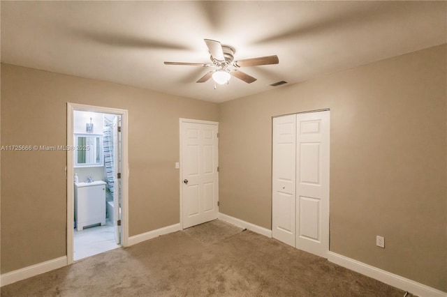 unfurnished bedroom with ceiling fan, a closet, and carpet