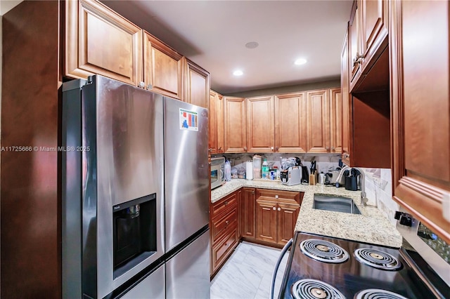 kitchen with stainless steel appliances and light stone countertops