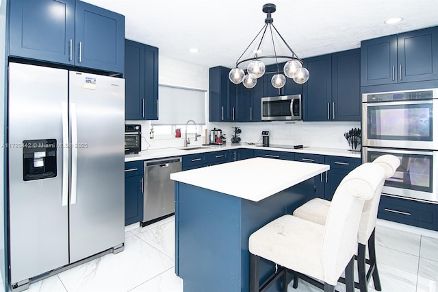 kitchen with decorative light fixtures, stainless steel appliances, a kitchen bar, a kitchen island, and sink